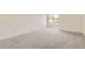 Spacious, carpeted bedroom with a window providing natural light at 3558 S Depew St # 302, Denver, CO 80235