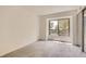 Bright, carpeted bedroom with a window and a sliding closet door at 3558 S Depew St # 302, Denver, CO 80235