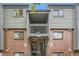 Exterior of building featuring brick facade, upper balcony and direct access stairs at 3558 S Depew St # 302, Denver, CO 80235
