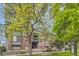 Exterior view of building showcasing mature trees, landscaping and access stairs at 3558 S Depew St # 302, Denver, CO 80235
