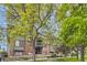 Exterior view of building showcasing mature trees and landscaping at 3558 S Depew St # 302, Denver, CO 80235