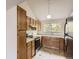 Kitchen with wooden cabinets and a window offering natural light at 3558 S Depew St # 302, Denver, CO 80235