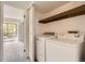 Convenient laundry room with included washer and dryer, shelving, and natural light at 3558 S Depew St # 302, Denver, CO 80235