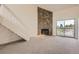 Bright living room with stone fireplace and balcony access at 3558 S Depew St # 302, Denver, CO 80235