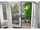 View from an open door to a wooden balcony with black wrought iron railings and an array of colorful plants and flowers at 1502 Columbine Ave, Boulder, CO 80302