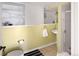 Bathroom with a sink, a shower, a toilet, open shelving and yellow and white walls at 1502 Columbine Ave, Boulder, CO 80302