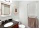 Bathroom featuring a granite countertop sink, and framed vanity mirror, brightened by a large window at 1502 Columbine Ave, Boulder, CO 80302