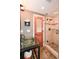 Bathroom features a glass vessel sink, a glass enclosed shower, and a door to the living space at 1502 Columbine Ave, Boulder, CO 80302