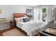 Cozy bedroom with a queen bed, hardwood floors, and a sliding glass door to the patio at 1502 Columbine Ave, Boulder, CO 80302