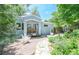Charming blue cottage-style home with a stone walkway, beautiful garden and welcoming porch at 1502 Columbine Ave, Boulder, CO 80302