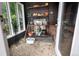Sunroom with stone floor and shelving that is perfect for plants and gardening equipment at 1502 Columbine Ave, Boulder, CO 80302