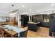 Open kitchen and dining area with island, hardwood floors, and modern lighting at 1502 Columbine Ave, Boulder, CO 80302
