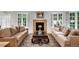 Sun-filled living room with a stone fireplace, large windows, and hardwood floors at 1502 Columbine Ave, Boulder, CO 80302