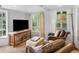 Cozy living room with large windows, hardwood floors, leather armchairs, and a decorative console table at 1502 Columbine Ave, Boulder, CO 80302