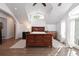 Bright main bedroom with hardwood floors, vaulted ceilings, and large windows facing the backyard at 1502 Columbine Ave, Boulder, CO 80302