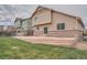 Backyard of home featuring a large concrete patio, grass area, and fenced yard at 24288 E Brandt Ave, Aurora, CO 80016