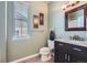 Bathroom featuring a modern vanity with granite countertops, art, and a window at 24288 E Brandt Ave, Aurora, CO 80016