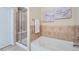 Bathroom featuring a soaking tub with tile backsplash and glass shower with a bench at 24288 E Brandt Ave, Aurora, CO 80016