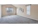 Bright bedroom featuring plush carpeting, base molding and three large windows at 24288 E Brandt Ave, Aurora, CO 80016