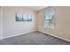 Neutral bedroom featuring plush carpet, base trim, and a large window at 24288 E Brandt Ave, Aurora, CO 80016