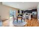 Inviting dining area with hardwood floors, stylish table, and easy access to the modern kitchen at 24288 E Brandt Ave, Aurora, CO 80016
