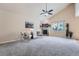 Cozy living room featuring a fireplace, vaulted ceiling, ceiling fan, and natural light at 24288 E Brandt Ave, Aurora, CO 80016