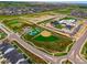 Aerial view of neighborhood amenities, showcasing a baseball field, recreation areas, and community buildings at 5737 Amarosa Dr, Parker, CO 80134
