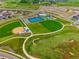 An aerial view showcases community amenities with playing fields, tennis courts and lush green spaces at 5737 Amarosa Dr, Parker, CO 80134