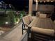 Comfortable outdoor seating area on a covered patio, perfect for relaxing and entertaining under soft lighting at 5737 Amarosa Dr, Parker, CO 80134