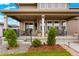 Back porch with outdoor seating and manicured landscaping at 5737 Amarosa Dr, Parker, CO 80134