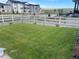 A well maintained grassy yard framed by a white fence offers a private outdoor space at 5737 Amarosa Dr, Parker, CO 80134