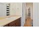 Well-lit bathroom featuring a vanity with a sink, modern fixtures, and a view into the hallway at 5737 Amarosa Dr, Parker, CO 80134