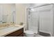 Bathroom showcasing a glass-enclosed shower with decorative tiles and a vanity with a sink and modern fixtures at 5737 Amarosa Dr, Parker, CO 80134