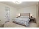 Cozy bedroom with ensuite bathroom featuring dual nightstands and plush carpet at 5737 Amarosa Dr, Parker, CO 80134
