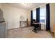 Office space that features large windows with curtains, a desk with a chair, and a dresser with storage at 5737 Amarosa Dr, Parker, CO 80134