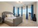 Bedroom with grey upholstered headboard, desk, and blue curtains at 5737 Amarosa Dr, Parker, CO 80134