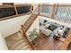 Elegant staircase with wooden railings, leading to a living room featuring a fireplace and comfortable seating at 5737 Amarosa Dr, Parker, CO 80134