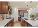 Modern kitchen featuring custom cabinets, stone backsplash, stainless steel appliances, and hardwood floors at 5737 Amarosa Dr, Parker, CO 80134