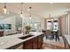Gourmet kitchen with center island open to living room, dining area, and stone fireplace at 5737 Amarosa Dr, Parker, CO 80134