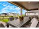 Covered patio with an outdoor dining table and neighborhood view at 5737 Amarosa Dr, Parker, CO 80134
