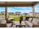 Covered porch with outdoor seating area and neighborhood view at 5737 Amarosa Dr, Parker, CO 80134