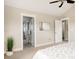 Bedroom with doors leading to the bathroom and closet with soft decor and light at 2879 Shadow Lake Rd, Lafayette, CO 80026
