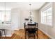 Bright dining room featuring hardwood floors and a modern chandelier with a large window at 2879 Shadow Lake Rd, Lafayette, CO 80026