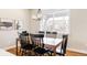Inviting dining room with wood table, black chairs, chandelier, and large window for natural light at 2879 Shadow Lake Rd, Lafayette, CO 80026