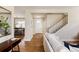 Inviting entryway with hardwood floors leading to a dining area and staircase at 2879 Shadow Lake Rd, Lafayette, CO 80026