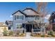 Charming two-story home with stone accents, a covered front porch, and manicured landscaping at 2879 Shadow Lake Rd, Lafayette, CO 80026