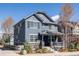 Charming two-story home with stone accents, a covered front porch, and manicured landscaping at 2879 Shadow Lake Rd, Lafayette, CO 80026