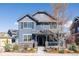 Charming two-story home with blue siding, stone accents, covered porch, and well-maintained landscaping at 2879 Shadow Lake Rd, Lafayette, CO 80026