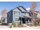 Beautiful two-story home with blue siding, stone accents, covered porch, and well-maintained landscaping at 2879 Shadow Lake Rd, Lafayette, CO 80026
