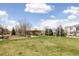 Serene green space with lush grass, trees, and walking paths, perfect for relaxation and recreation at 2879 Shadow Lake Rd, Lafayette, CO 80026